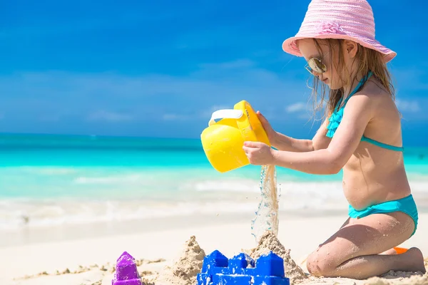 Urocza dziewczynka gra z piasku na plaży tropikalnej — Zdjęcie stockowe