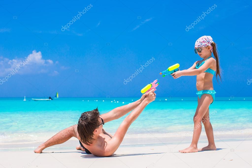 Happy father with his little kid enjoying beach vacation