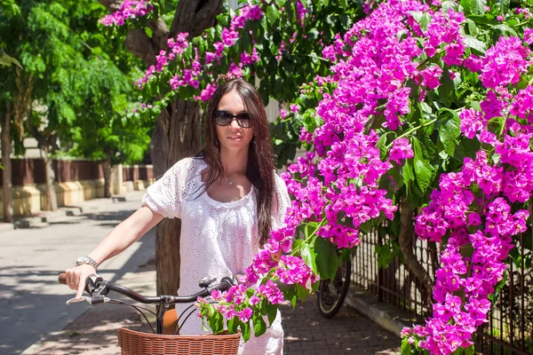 Young pretty woman on bicycle in summmer vacation — Stock Photo, Image