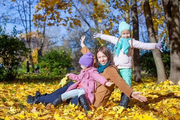 Little cute girls and young mother in autumn park have fun — Stock Photo, Image