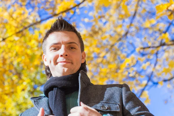 Happy young man in autumn park — Stock Photo, Image