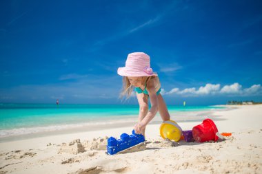 küçük kız sırasında tatil tropikal plaj oyuncakları ile oynarken