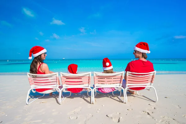 Happy family of four in Santa Hat on summer vacation — Stock Photo, Image