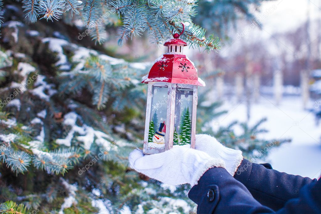 Beautiful red decorative Christmas lantern on warm mittens Stock Photo ...