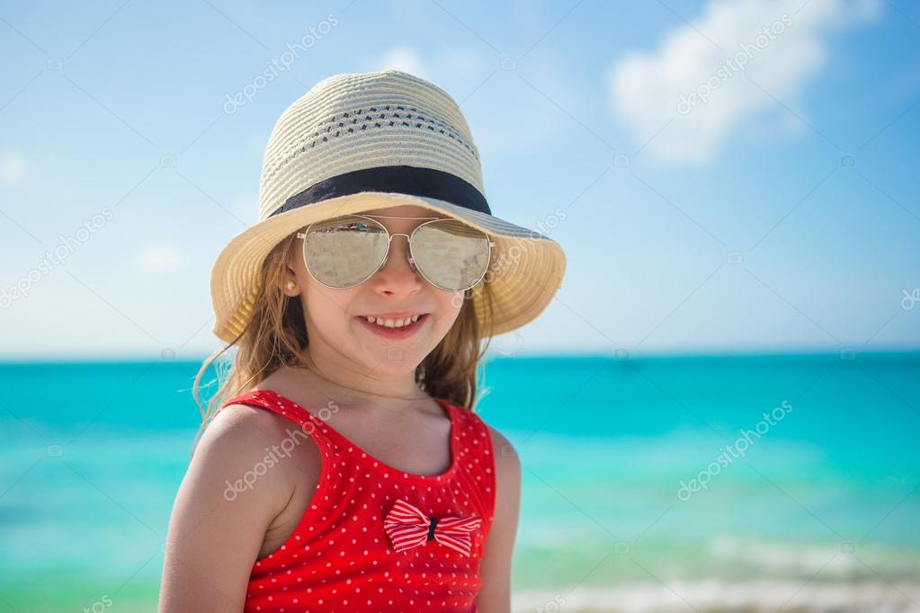 Happy little girl in hat on beach during summer vacation Stock Photo by ...