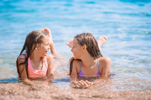 Adorable little girls having fun on the beach — Stock Photo, Image