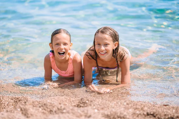 Adorable little girls having fun on the beach — Stock Photo, Image