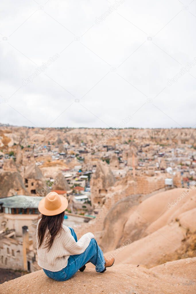 Young woman on the edge of canyon in Cappodocia