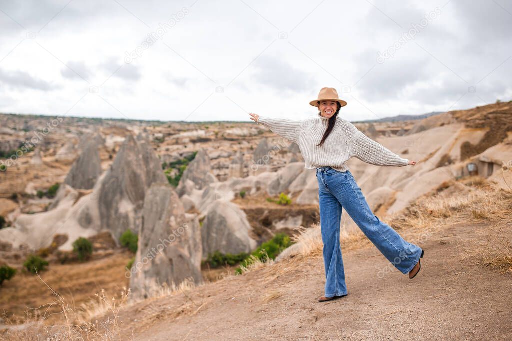 Young woman on the edge of canyon in Cappodocia