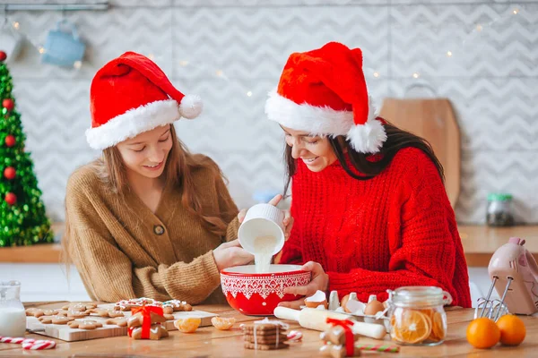 Happy family mother and daughter bake cookies for Christmas — Stock Photo, Image