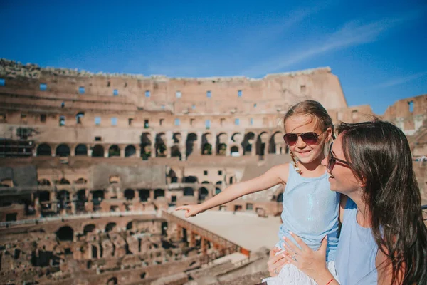 Happy family in Rome background of Coliseum. Family portrait at famous places in Europe