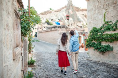 Happy couple on vacation in Europe walking in old streets