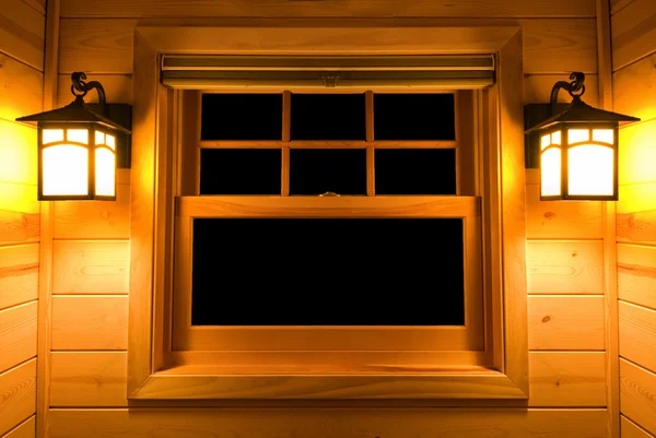 Inside view of a cedar cabin window with lights on — Stock Photo, Image