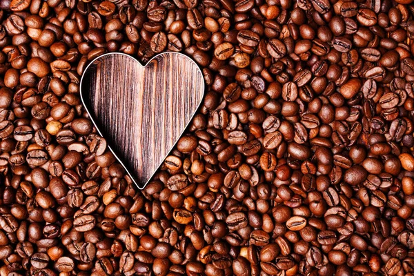 Fond de grains de café et un cœur de café, la vue de dessus — Photo
