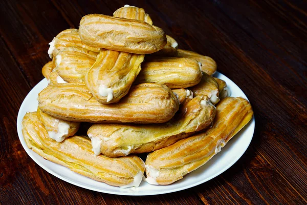 Homemade traditional French pastries eclairs with custard filling inside