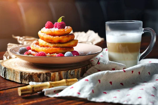 Délicieux gâteaux au fromage à la crème sure et aux baies, framboises et prunes avec garniture de sucre en poudre. Délicieux dessert sucré au fromage cottage — Photo