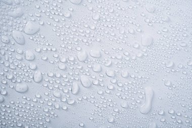 Transparent water droplets from spray on white background