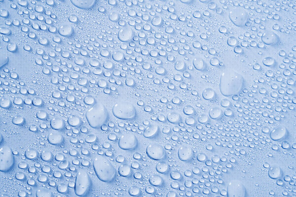 Cosmetics moisturizing liquid drops on a light blue pastel background. Hyaluronic acid, toner or lotion