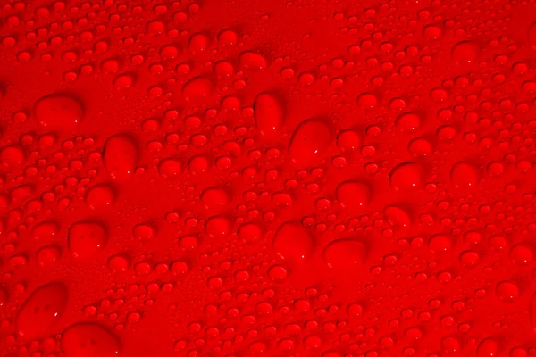 Transparante heldere rode vloeibare serum gel vlek met luchtbellen textuur achtergrond — Stockfoto