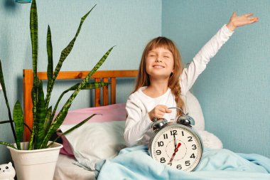 Baby girl woke up in a good mood, stretching. I slept well, its time to get up and good morning. Healthy sleep. clipart