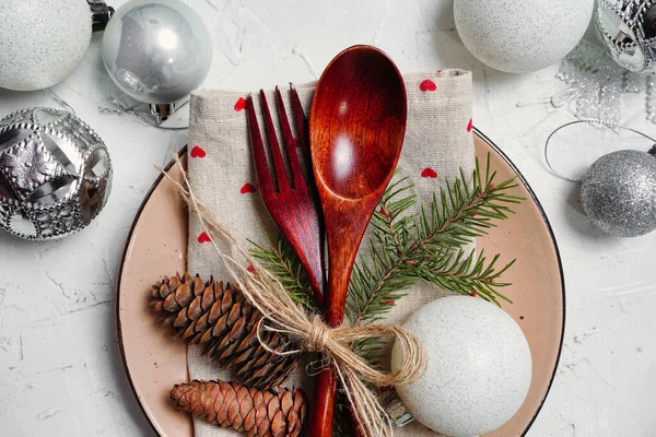 Christmas background with New Year decorations and set table. Spoon and fork, silver balls as serving of dinner table. High quality photo