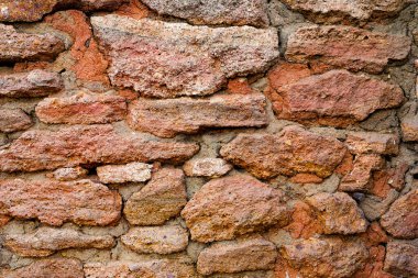 Eski kırmızı desenli, turuncu taş duvarın arka planı. Yüksek kalite fotoğraf