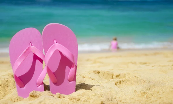女孩的拖鞋在沙滩上 — 图库照片