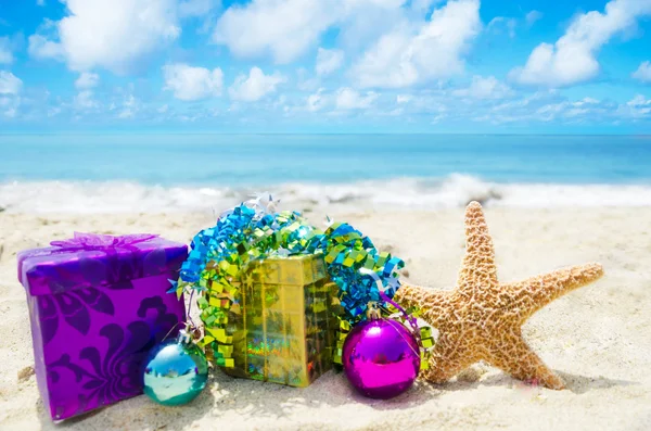 Starfish with gift boxes on beach - holiday concept