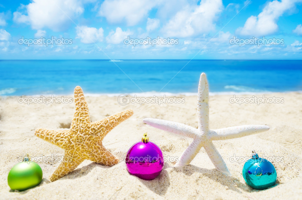 Two Starfishes with Christmas balls on the beach - holiday conce