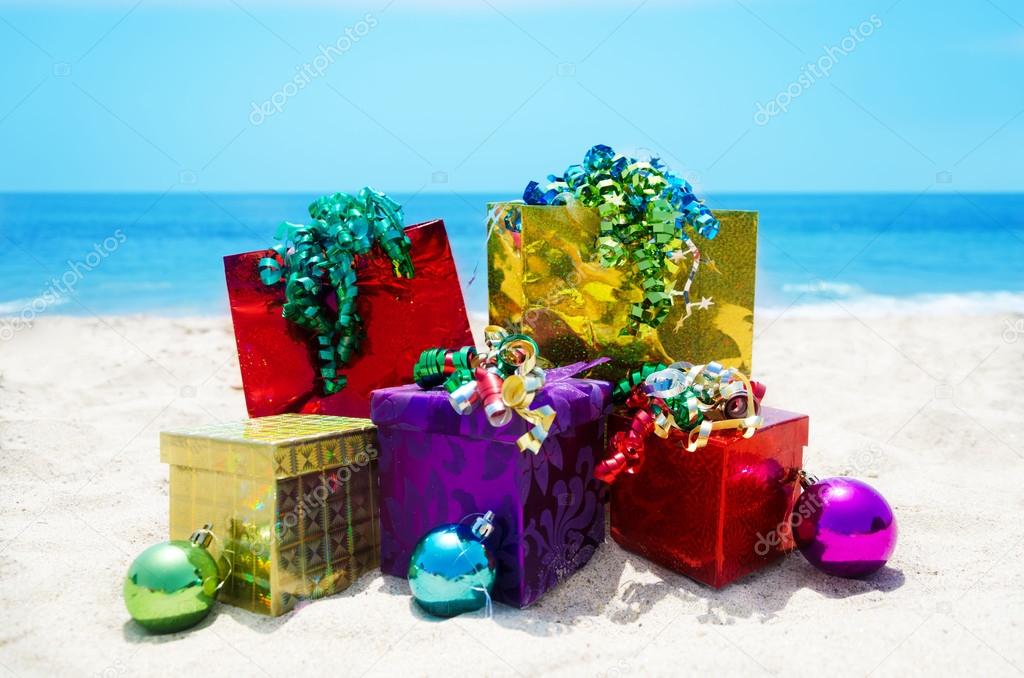 Gifts with Christmas ball on the beach