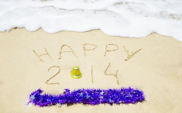 Sign "Happy 2014" on the sand - holiday concept — Stock Photo, Image