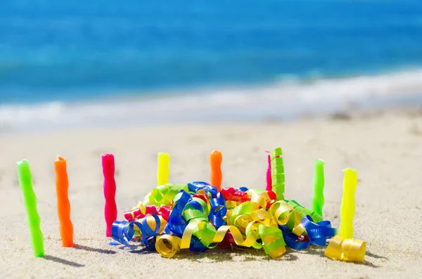 Candles with Birthday decorations on the beach — Stock Photo, Image