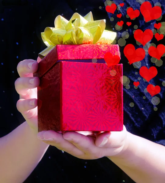 Gift box in woman's hands — Stock Photo, Image