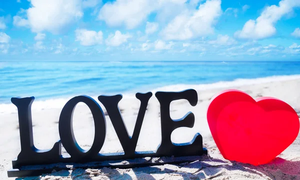 Sign "LOVE" with heart on the beach — Stock Photo, Image