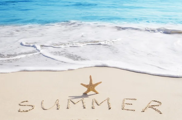 Ondertekenen "zomer" met zeester op het strand — Stockfoto