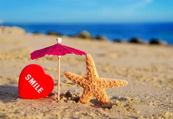 Starfish with heart on the sandy beach — Stock Photo, Image