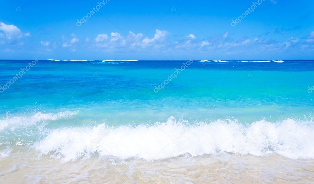 Gentle waves on the sandy beach in Hawaii