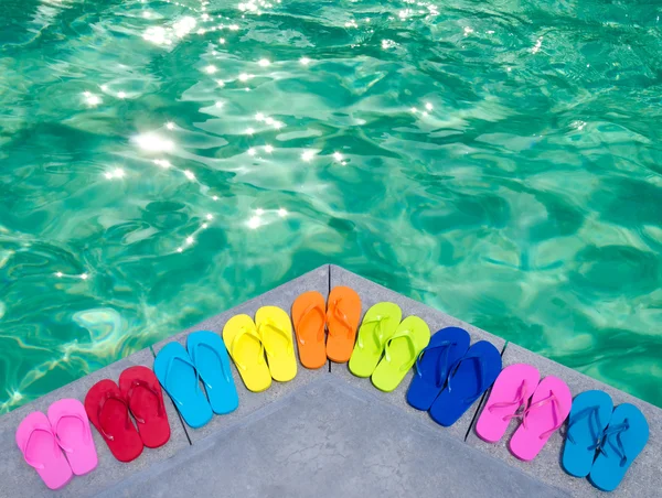 Color flip flops by the pool — Stock Photo, Image