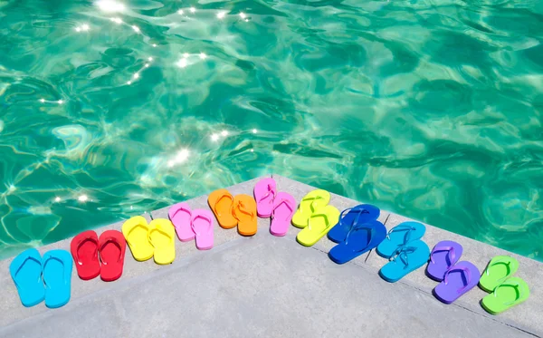 Color flip flops by the pool — Stock Photo, Image