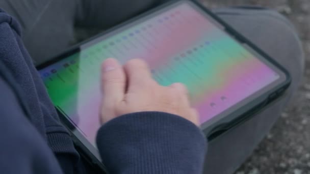 하늘색 후드를 남자가 태블릿을 사용하여 소매를 착용하고 풍경을 배경으로 안개가 — 비디오