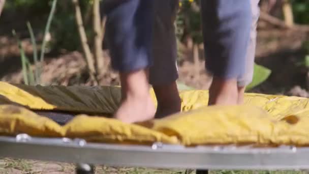 Close Child Feet Jumping High While Playing Yard Small Trampoline — Vídeo de Stock