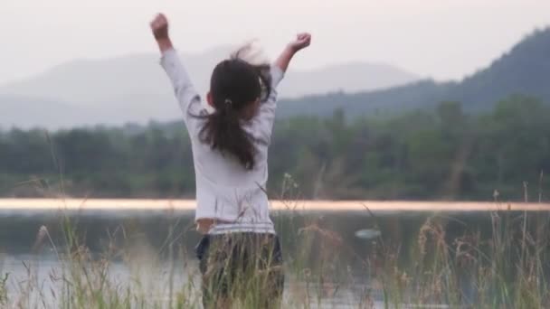 Rear View Cute Little Girl Raising Her Hand Jumping Summer — стоковое видео