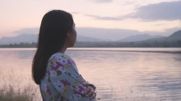 Young Asian Woman Crossing Arms Feeling Alone Lake Winter Sunset — Video Stock