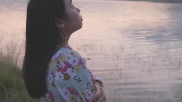 Young Asian Woman Crossing Arms Feeling Alone Lake Winter Sunset — Stockvideo