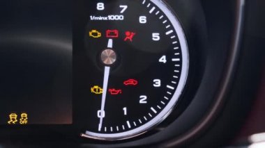 Engine rpm. Interior of a modern car, dashboard with an engine speed dial and moving white arrow.
