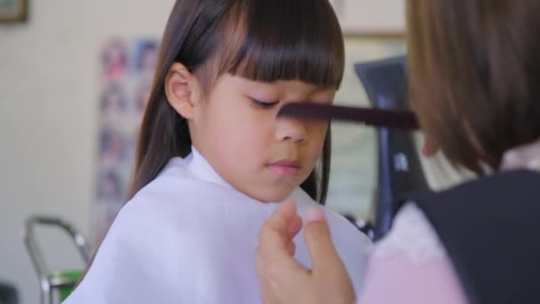 Asyalı Küçük Kız Bir Kuaför Tarafından Kuaförde Saçını Kestiriyor Kuaför — Stok video