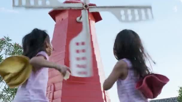Két Nővér Játszik Szélmalomnál Testvérlányok Élvezték Nézni Szélmalmokat Szélben — Stock videók