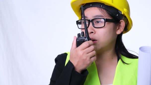 Female Architect Helmet Holding Construction Plans Using Walkie Talkie Talk — Stock Video