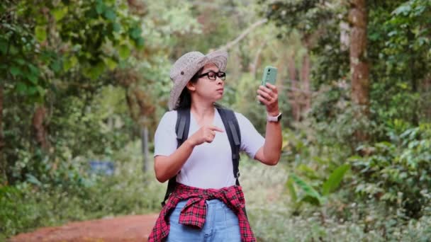 Female Traveler Uses Smartphone Locate Navigate While Backpacking Tropical Forest — Stock Video