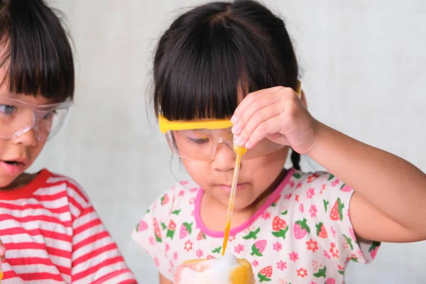 子どもたちは教室で科学実験を学び 行っています 家庭教育のための科学実験をしている2人の妹 自宅で子供たちのための簡単で楽しい科学実験 — ストック写真